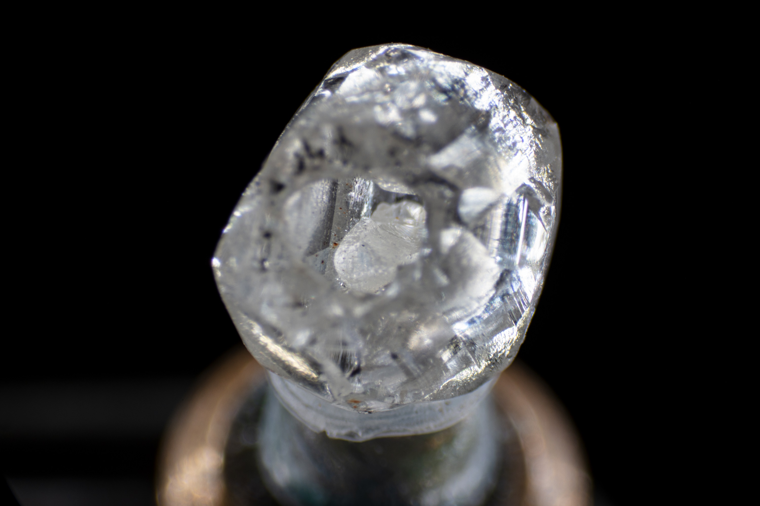 Optical image showing a small diamond crystal nestled in the cavity of a 0.329ct rough diamond. Photo by Danny Bowler
